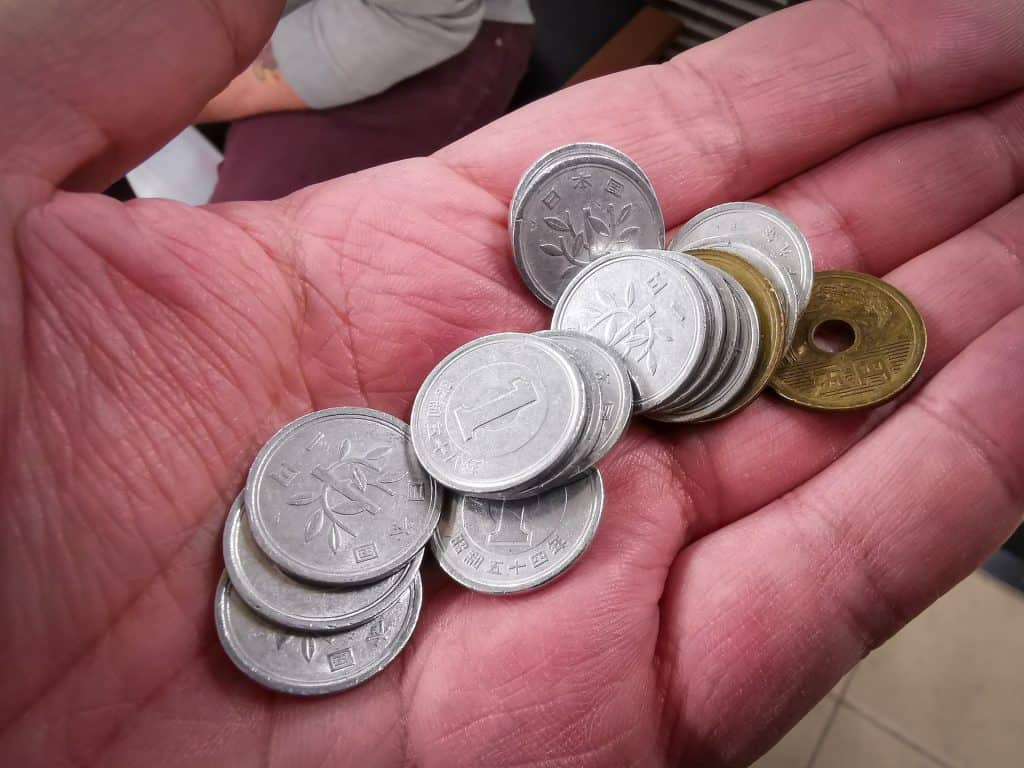 Japanese yen coins in hand