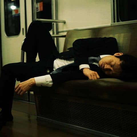 Japanese man asleep on train