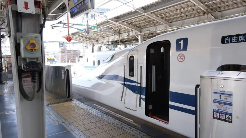 shinkansen parked at platform with door open