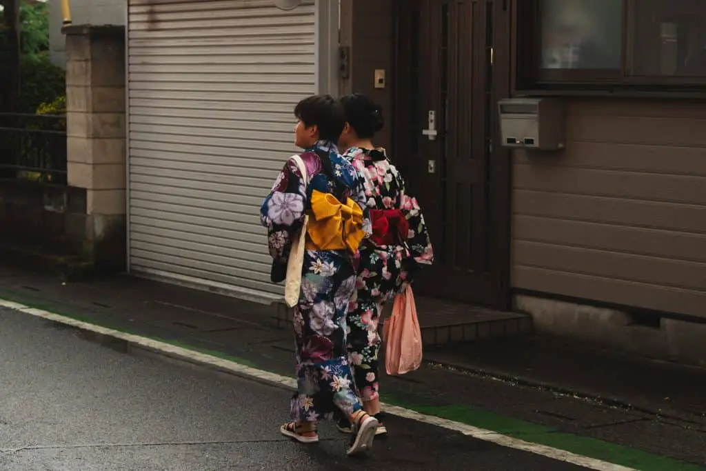 two people in japan in a kimono walking
